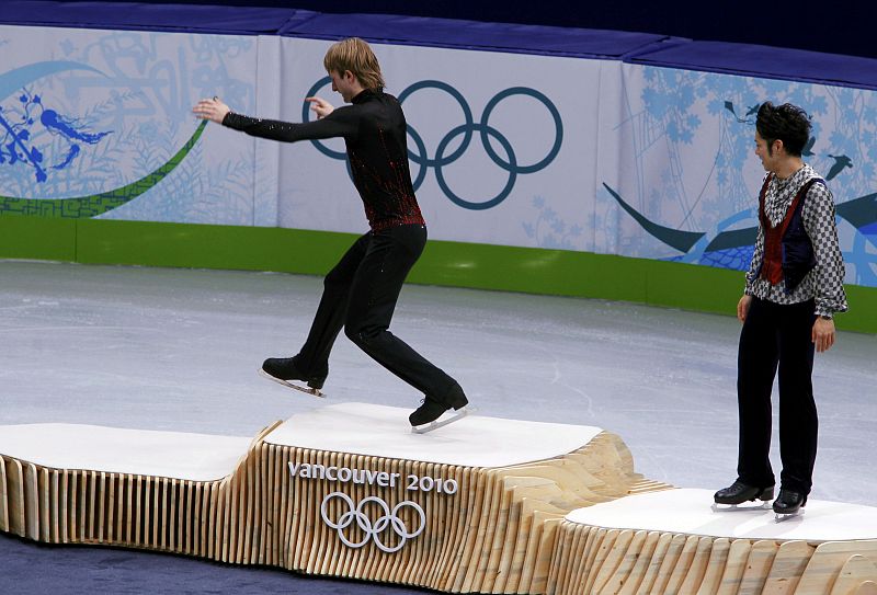 Coach Zmievskaya talks to Weir of the U.S. after his routine during the men's free skating figure skating competition at the Vancouver 2010 Winter Olympics