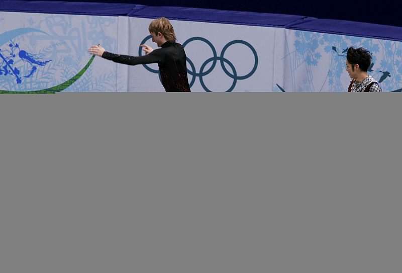Silver medallist Plushenko walks across the gold medal position on the podium after the men's free skating figure skating competition at the Vancouver 2010 Winter Olympics