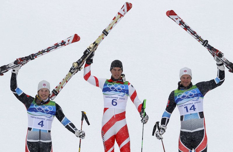 Norway's Jansrud, Switzerland's gold medalist Janka and Norway's Svindal celebrate during the flowers ceremony of the men's alpine skiing giant slalom event at the Vancouver 2010 Winter Olympics in Whistler