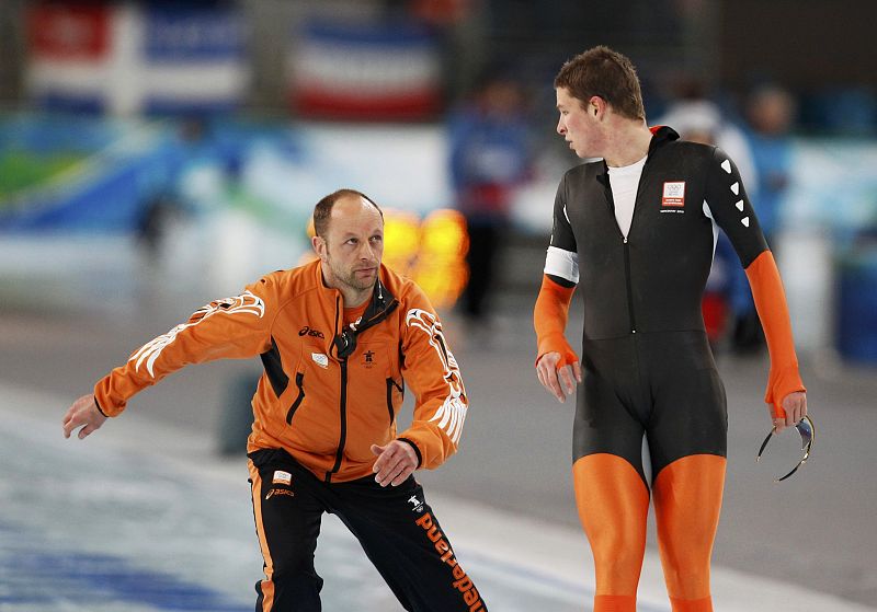 Kramer of the Netherlands looks at his coach Kemkers after finishing his race in the men's 10000 metres speed skating competition at the Vancouver 2010 Winter Olympics