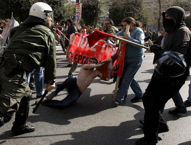 Protesters clash with riot policemen during an anti-government rally in Athens