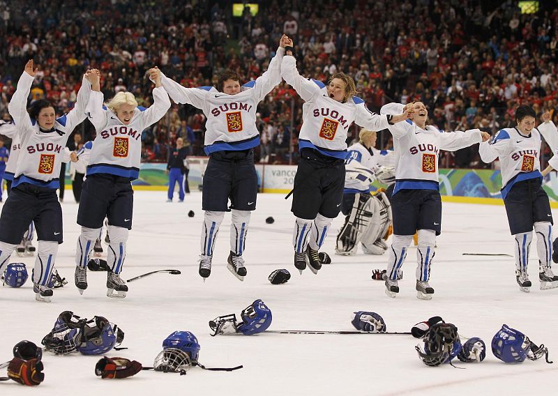 Finland's hockey team celebrates winning in overtime against Sweden in their ice hockey bronze medal game at the Vancouver 2010 Winter Olympics