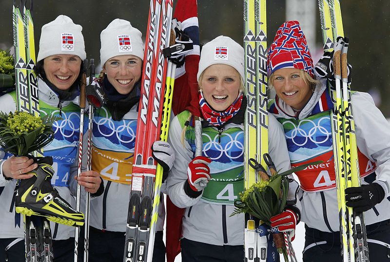 Norway's team celebrate their victory in women's 4x5 kilometres relay classic/free cross-country skiing final event at the Vancouver 2010 Winter Olympics in Whistler