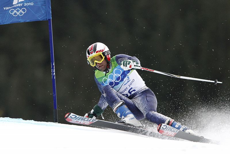 Pakistan's Abbas clears a gate during the first run of the men's alpine skiing giant slalom event at the Vancouver 2010 Winter Olympics in Whistler