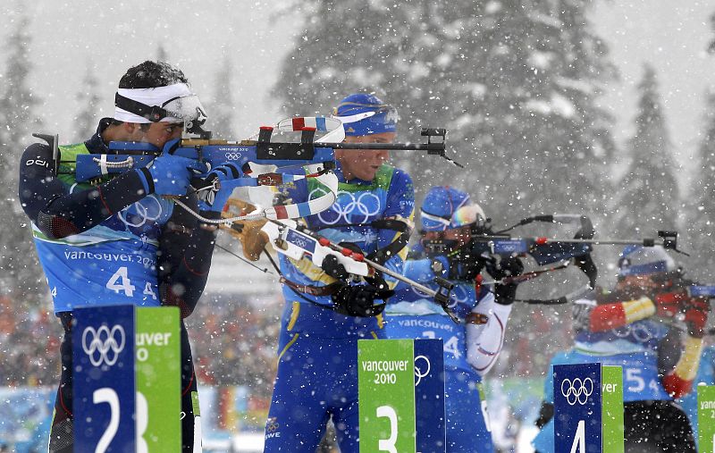 France's Fourcade shoots during men's 4 x 7.5 km relay biathlon final at Vancouver 2010 Winter Olympics in Whistler