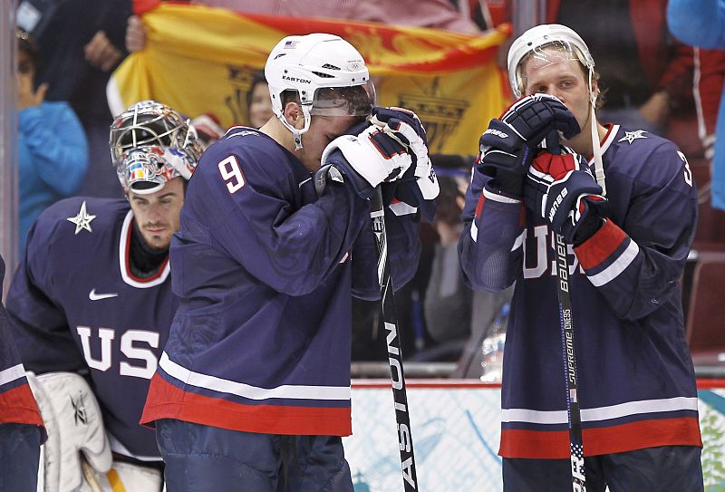 U.S. team members dejected after Canada won the gold medal in hockey at the Vancouver 2010 Winter Olympics