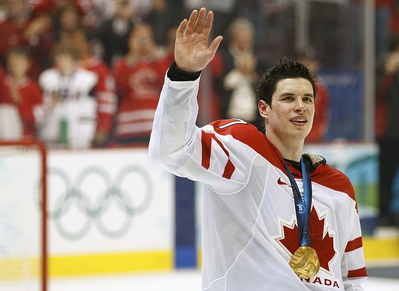 Canada's Crosby waves to the crowd during the medal ceremony after their gold medal hockey game at the Vancouver 2010 Winter Olympics