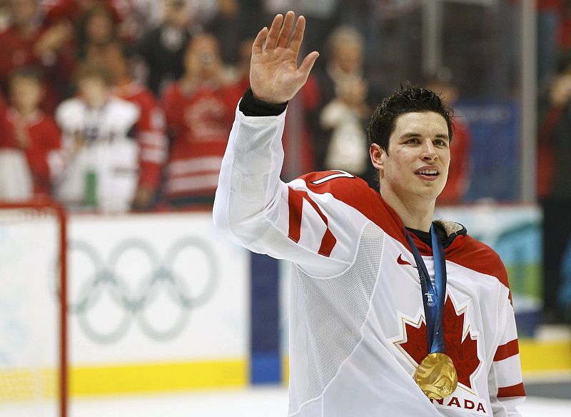 Canada's Crosby waves to the crowd during the medal ceremony after their gold medal hockey game at the Vancouver 2010 Winter Olympics
