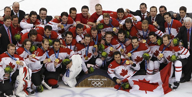 Canada team members pose with their medals after defeating the U.S. in their gold medal hockey game at the Vancouver 2010 Winter Olympics