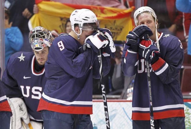 U.S. team members dejected after Canada won the gold medal in hockey at the Vancouver 2010 Winter Olympics