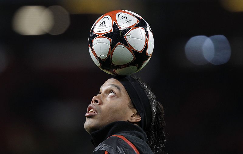 AC Milan's Ronaldinho balances a ball on his head before their Champions League last 16, second leg soccer match against Manchester United at Old Trafford in Manchester