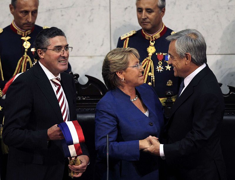 Chile's newly sworn-in President Pinera is saluted by former president Bachelet before receiving the sash from President of the Senate Jorge Pizarro in Valparaiso