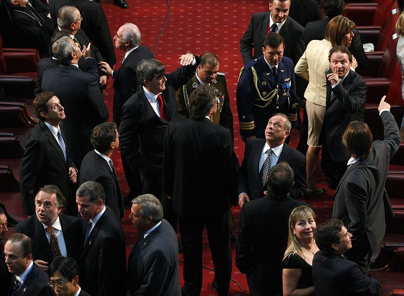 Members of the Congress and guests at the inauguration ceremony of Chile's president-elect Pinera react as a strong aftershock shook the region a few minutes before the ceremony began in Valparaiso