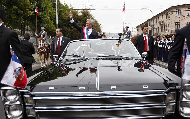 Chile's new President Sebastian Pinera waves from a car after leaving Chilean Congress building in Valparaiso city