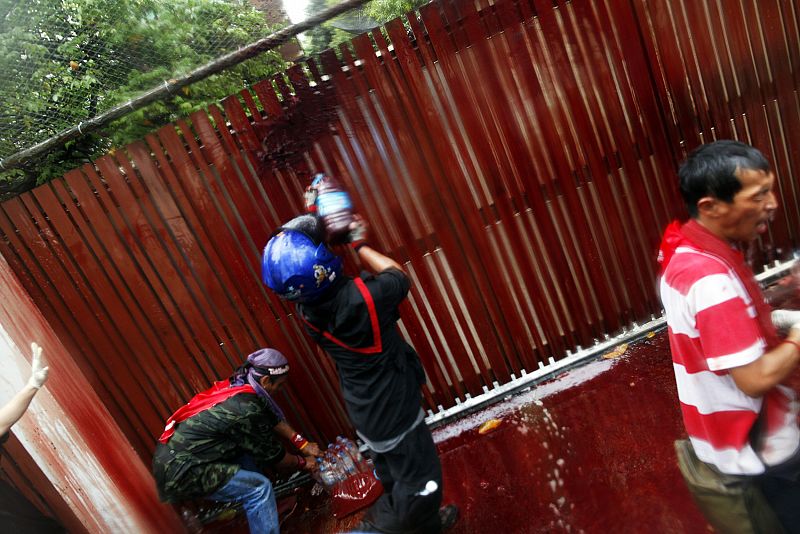 Manifestantes vertiendo su sangre contra la puerta de la casa del primer ministro