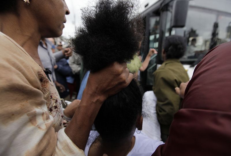 Security forces drag members of the Ladies in White into a bus after a march in Havana