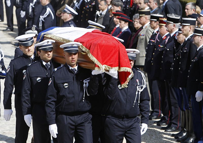 Colleagues carry the flag-drapped coffin of slain police officer Nerin during cermony in Melin