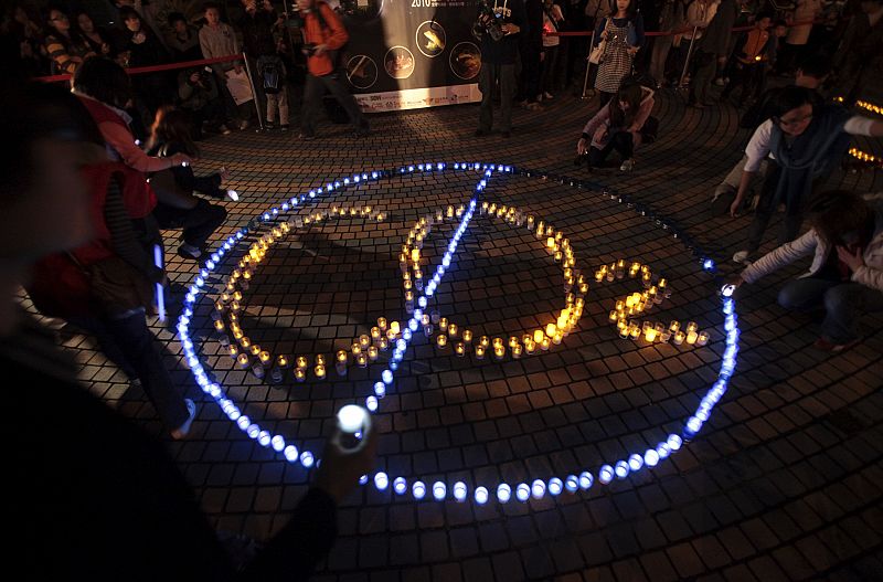 People arrange LED lights to form Earth Hour message in Taipei