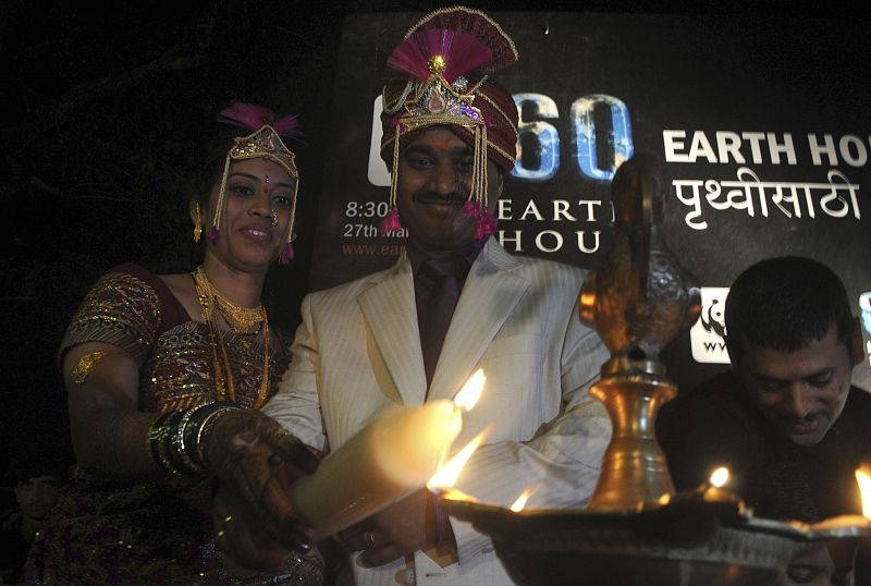 Newly wed couple Vishal and Ruchika Sawant participate in a candlelight vigil to mark earth hour in Mumbai