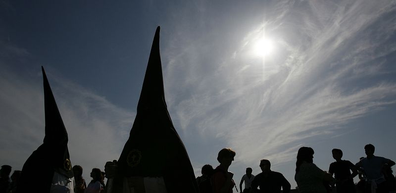 Penitents take part in the procession of "Amor" brotherhood during Holy Week in Cordoba
