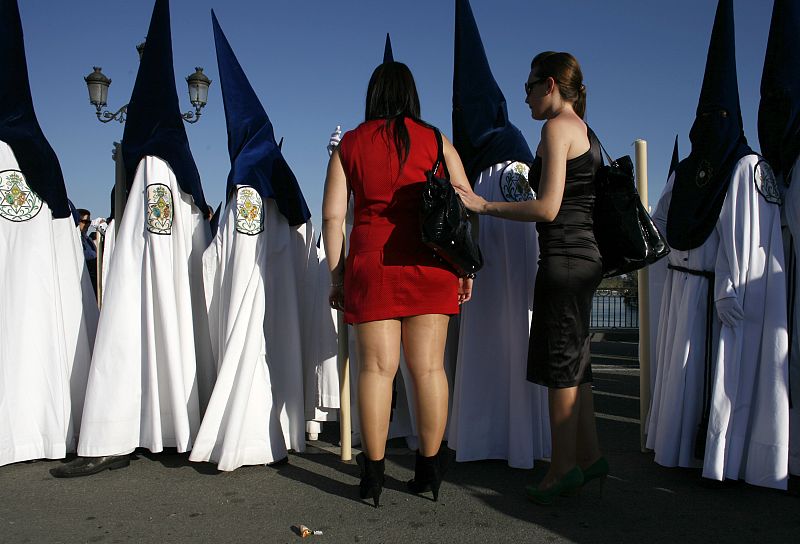 Penitents take part in the procession of "La Estrella" brotherhood during Holy Week in Seville