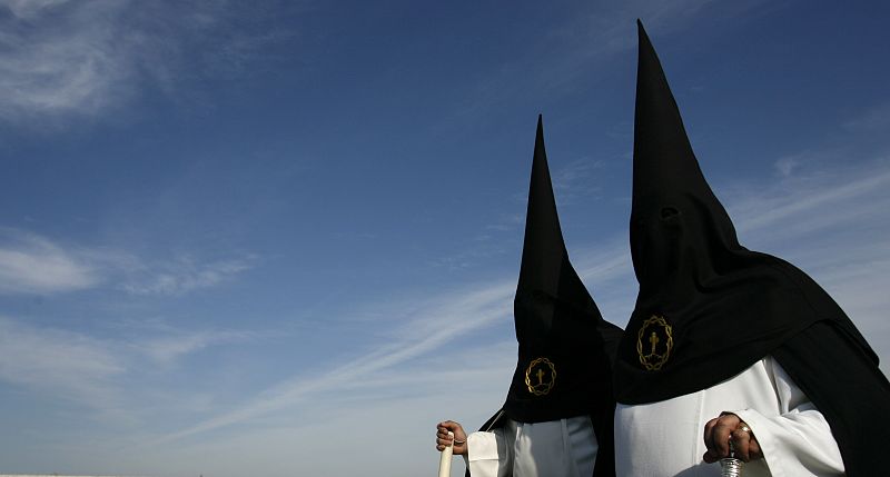 Penitents take part in the procession of "Amor" brotherhood during Holy Week in Cordoba