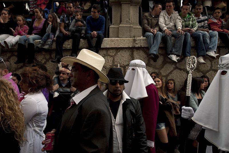 Penitents take part in a procession of the Gitanos brotherhood during Holy Week in the Andalusian city of Malaga