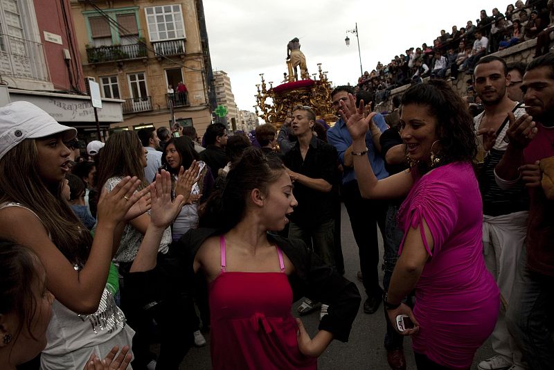 Gypsies dance as they take part in a procession of the Gitanos brotherhood during Holy Week in the Andalusian city of Malaga