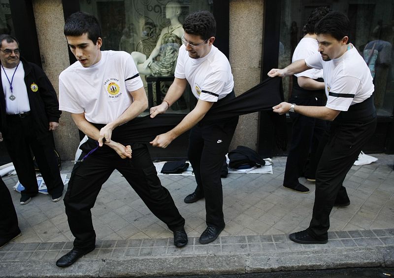 Costaleros, men who carry the statue of Christ or the Virgin, get ready for the "Nuestro Padre Jesus del Gran Poder y Maria Santisima de la Esperanza Macarena" Holy Week procession in Madrid