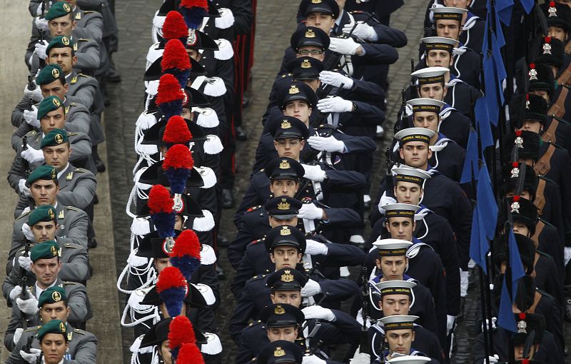 Italian soldiers stand at attention as Pope Benedict XVI arrives to lead the Easter mass in Saint Peter's Square at the Vatican