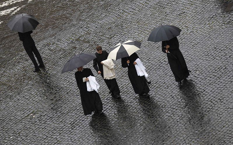 Priests arrive to take part in the Easter mass led by Pope Benedict XVI in Saint Peter's Square at the Vatican