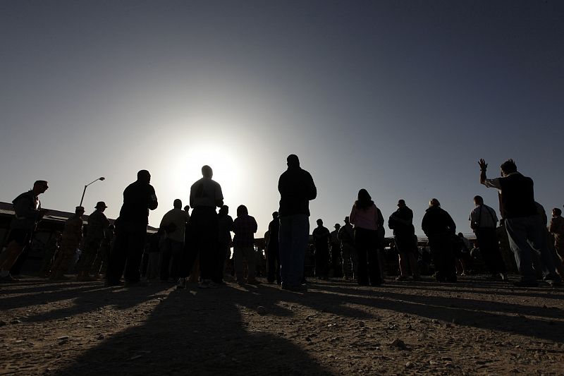 U.S. servicemen and womenn pray during an Easter service in Kandahar