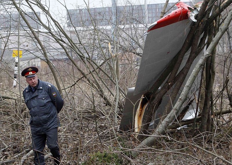 Interior Ministry officer stands guard near wreckage of Polish government Tupolev Tu-154 aircraft that crashed near Smolensk airport