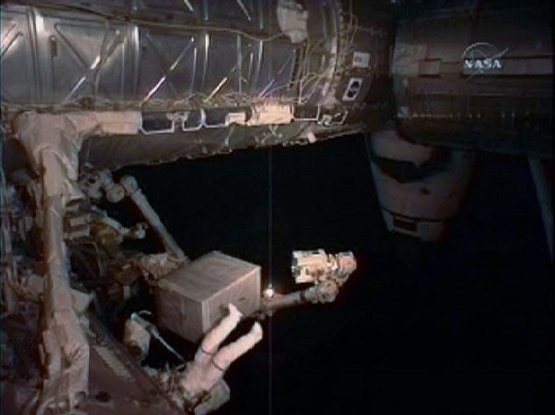 Space Shuttle Discovery astronaut Rick Mastracchio works on installing the new fully charged ammonia tank on the International Space Station during a spacewalk