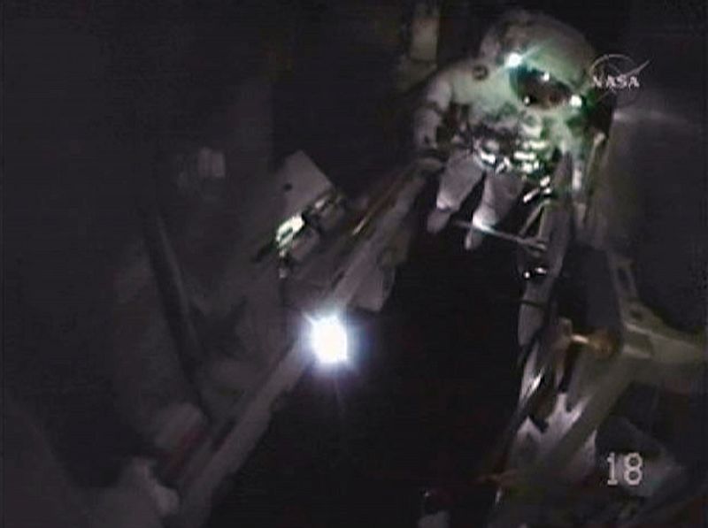 Space Shuttle Discovery astronaut Rick Mastracchio's helmet camera gives this view of astronaut Clayton Anderson during their spacewalk