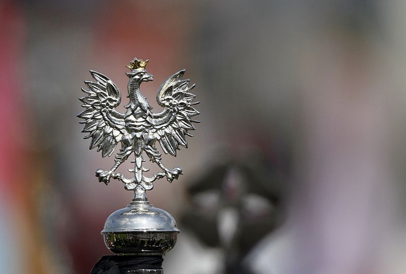 The White Eagle, national coat of arms of Poland is seen on the flag at the start of a commemoration service for late Polish President Lech Kaczynski and other plane crash victims at the Pilsudski square in Warsaw