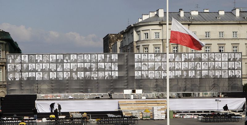 A Polish national flag flies at half mast in front of a stage being prepared by workers at Pilsudski square in Warsaw for a commemoration ceremony for victims of the last week's plane crash in Smolensk