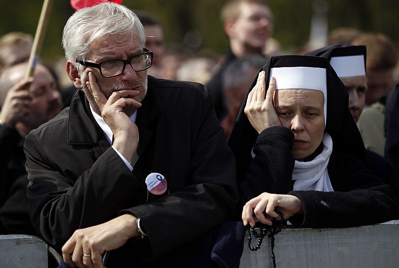 People attend commemoration service for late Polish President Lech Kaczynski and the other plane crash victims at the Pilsudski square in Warsaw