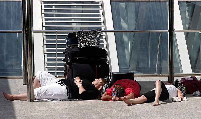 Sranded travellers soak up the sun outside Mallorca airport