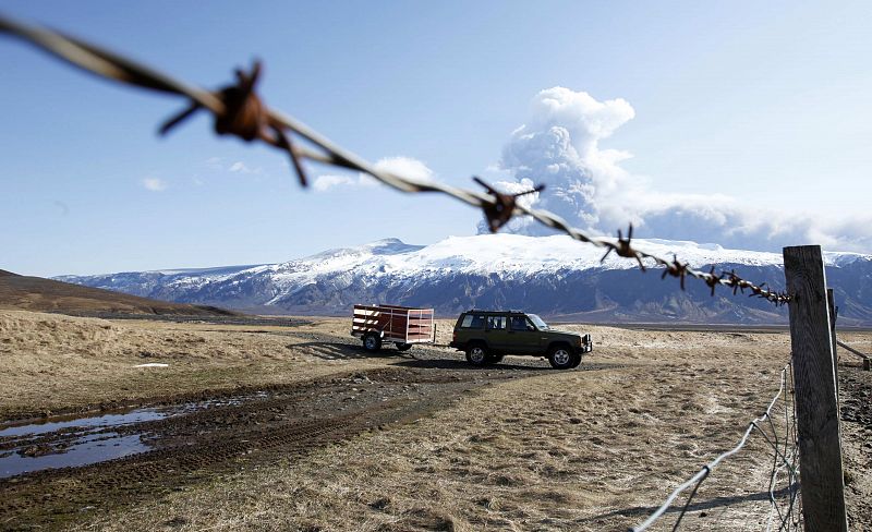 Sheep farmers bring lumber in a trailer to seal their sheep barn in Eyjafjallajokull