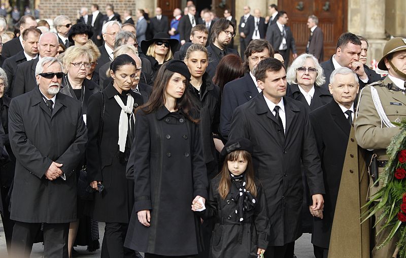 Brother and daughter of the late Polish President Lech Kaczynski walk after the coffins holding bodies of President Lech Kaczynski and his wife Maria in front of Mariacki Church in Krakow