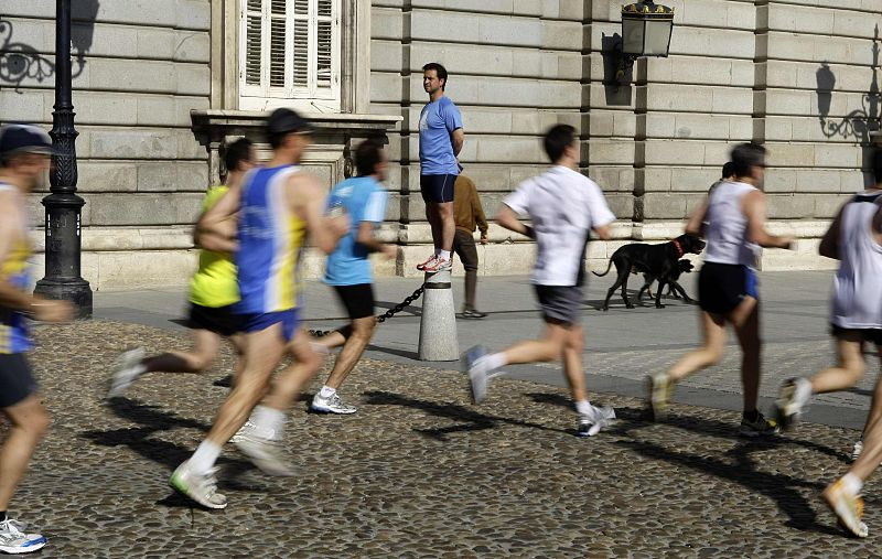 Participants run past Madrid's Royal Palace during the XXXIII Madrid marathon