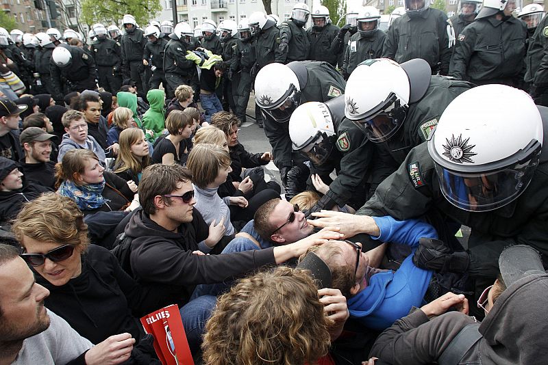 German riot police attempt to remove left-wing protestors blocking a street during May Day demonstrations in Berlin