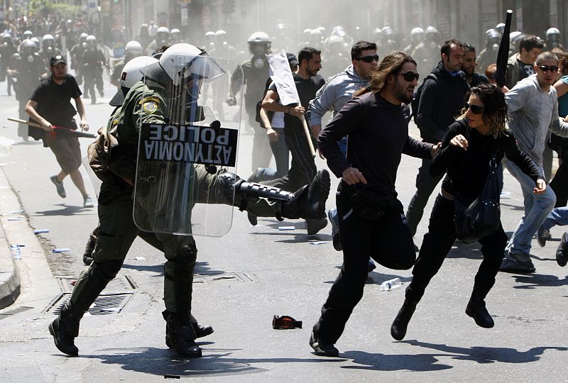 Policemen clash with protesters during riots at a May Day rally in Athens