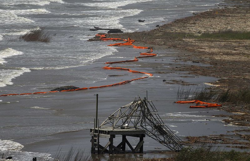 Oil booms are seen washed ashore on the coast of South Pass, south of Venice, Louisiana