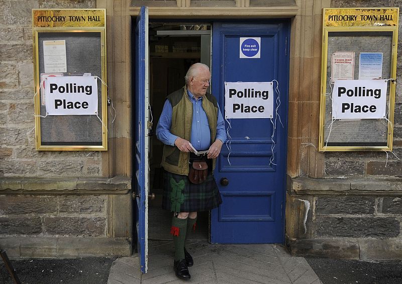 Voter leaves a polling station at Pitlochry Town Hall, Scotland