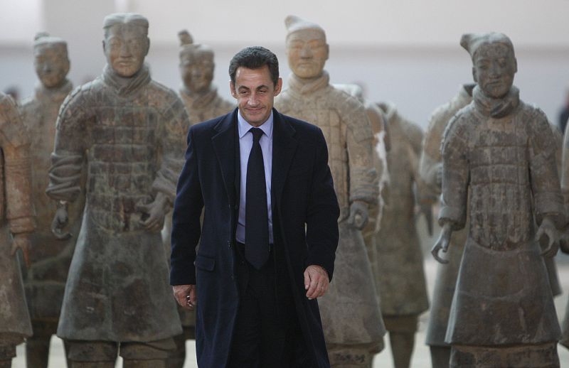 France's President Nicolas Sarkozy poses with preserved figures of warriors of the buried Terracotta Army in Xian