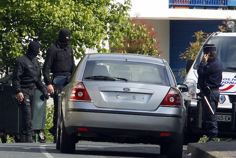 Hooded French anti-terrorist police work at the scene after the arrest of the suspected military leader of the Basque separatist movement ETA in Bayonne