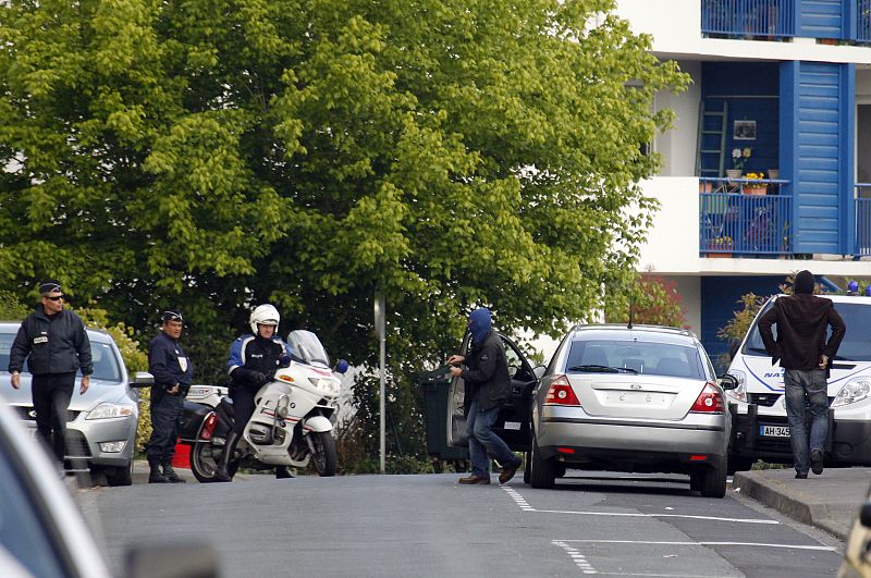 Hooded French anti-terrorist police work at the scene after the arrest of the suspected military leader of the Basque separatist movement ETA in Bayonne