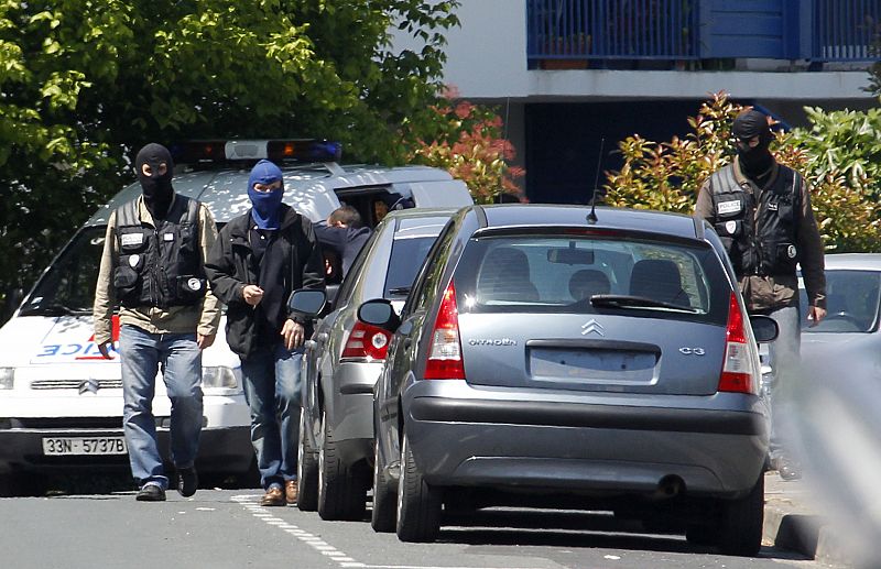 Hooded French anti-terrorist police seen after the arrest of the suspected military leader of the Basque separatist movement ETA in Bayonne